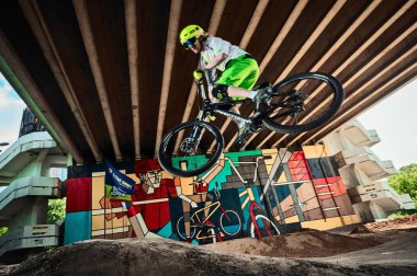 Atla ve dağ bisikletine bin. Dağ bisikleti sporunda binici iş başında. Bisikletçi bir dublör yapma ve atlama aşağı adım. Bisikletli havalı atlet bisikletçi. Mtb bisiklet.