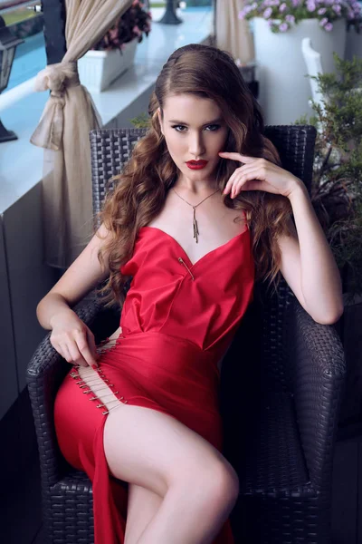 A sötét, göndör haj luxus piros ruhás, gyönyörű nő — Stock Fotó