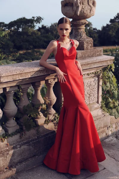 Linda jovem mulher com cabelo escuro em vestido vermelho elegante — Fotografia de Stock