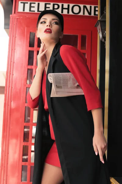 Όμορφο κορίτσι με σκούρα μαλλιά, με τα πόδια από το δρόμο, κόκκινο τηλέφωνο β — Φωτογραφία Αρχείου