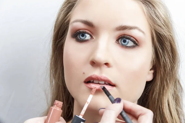 Process of applying makeup on the girls face close-up. Lip Makeup — Stock Photo, Image