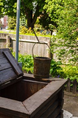 A well with a wooden frame, a crane-type lifting mechanism and a wooden bucket