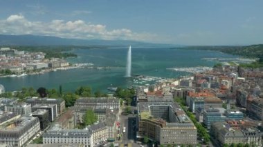 Day time 4k footage of Geneva aerial riverscape panorama with huge fountain, Switzerland  