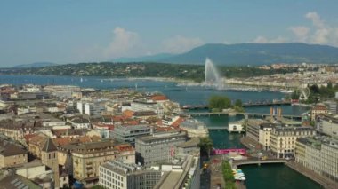 Day time 4k footage of Geneva aerial riverscape panorama with huge fountain, Switzerland  