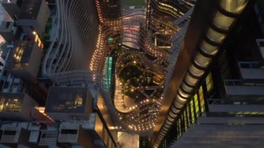 Alacakaranlık aydınlatmalı Singapur şehrinin Çin kenti havadan tepeden tırnağa panorama 4K görüntüleri