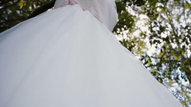 Bílé krajkové svatební šaty zavěsit na větev stromu — Stock video
