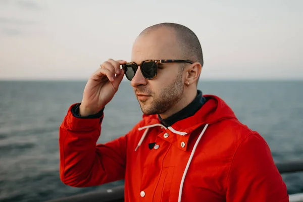 Man Stubble Red Jacket Black Sunglasses Smiles Ship Looking Sunset — 스톡 사진