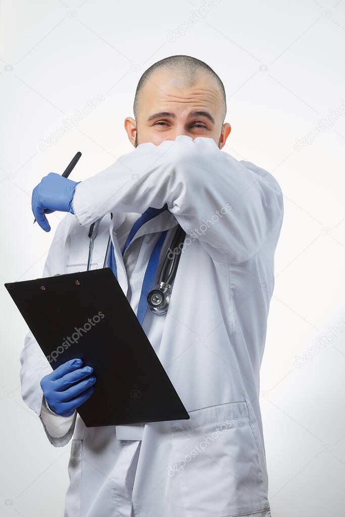 A doctor strongly coughing into his elbow covering mouth and nose. Coronavirus (COVID-19) protection prevention. Concept of stop spread of the virus.