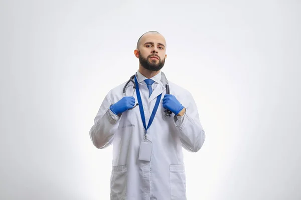 Serious Doctor Disposable Medical Gloves Holding Stethoscope Bald Physician Beard — Stock Photo, Image