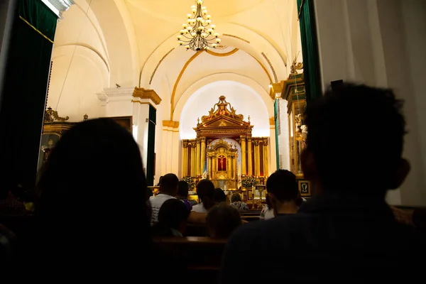 People praying at Mass in Catholic Church - Cathedral San Jose Antigua Guatemala inside - Baroque architecture
