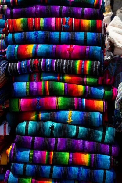 Typical Guatemalan fabrics, stacked colorful handmade fabrics - Antigua Guatemala