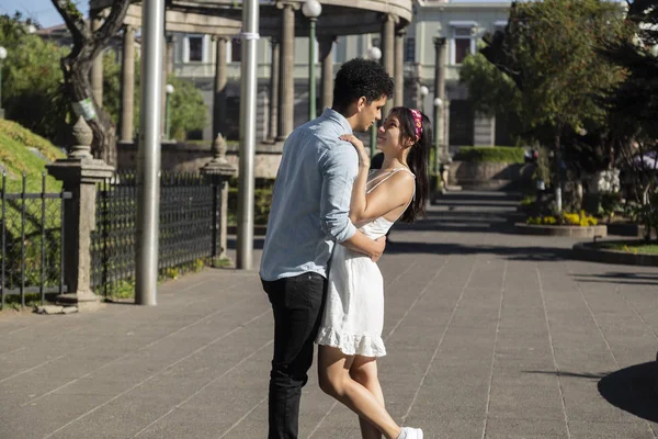 Hispanic couple walking in central park of Quetzaltenango - young couple looking each other in a park - Guatemala — 스톡 사진