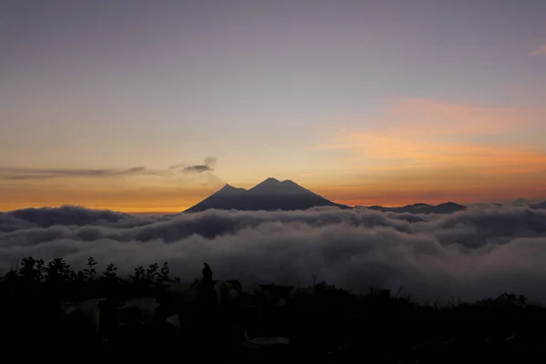 Sunset over Volcano of Fire and Acatenango Volcano - volcanoes surrounded by clouds - A view of the volcanoes of Guatemala — Stock Photo, Image