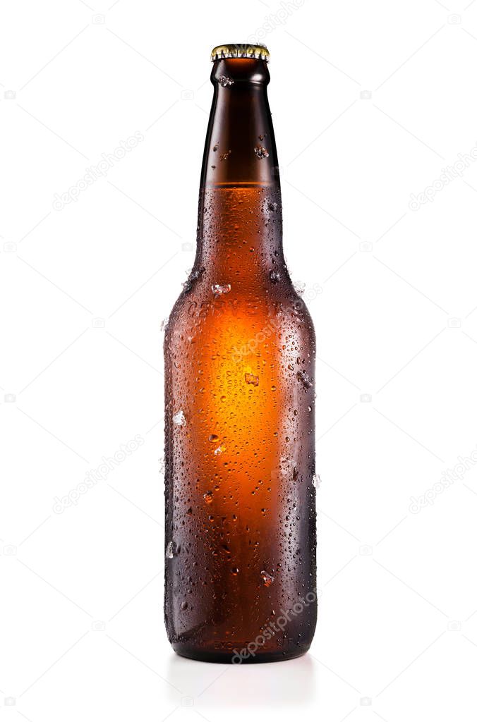 Bottle of beer with drops and ice pieces isolated on white backg