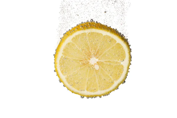 Slice of lemon in water with bubbles — Stock Photo, Image