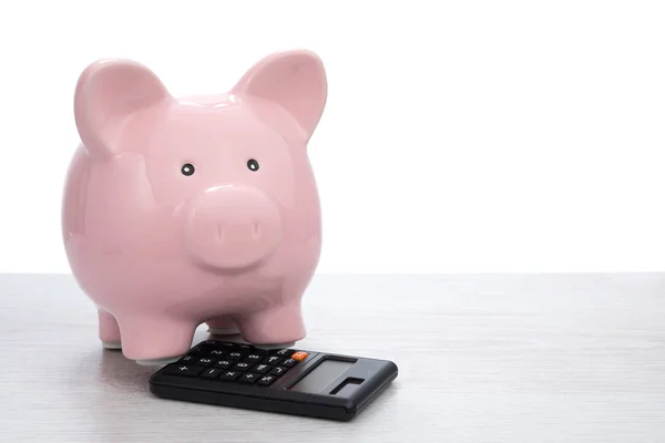 Piggy bank with calculator — Stock Photo, Image