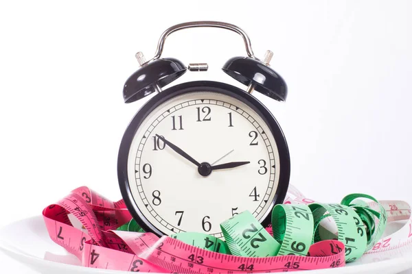 Classic alarm clock with measuring tapes — Stock Photo, Image