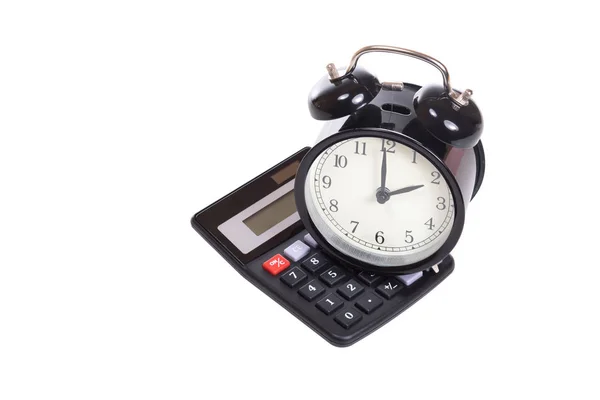 Reloj despertador retro en la parte superior de una calculadora — Foto de Stock