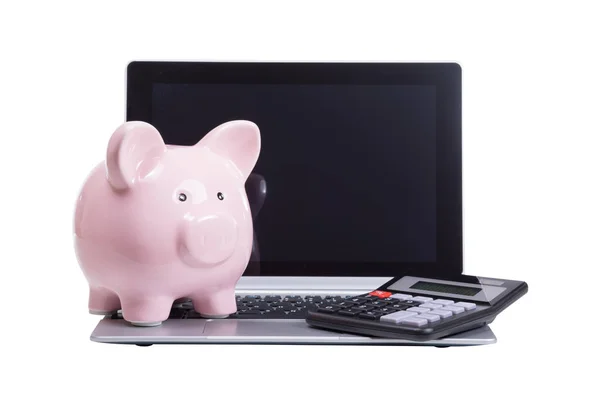 Piggy bank rosa e calculadora em um laptop — Fotografia de Stock