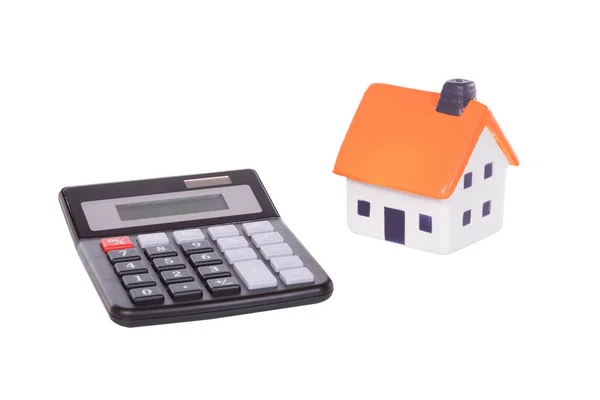 An isolated calculator and model toy house — Stock Photo, Image