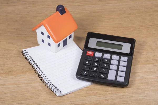 Little model house with calculator and notebook