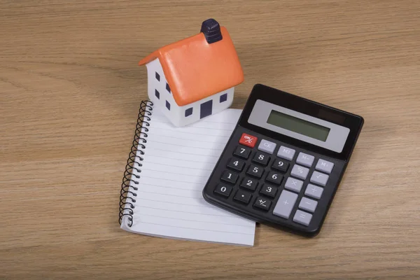 Calculator, model house and blank notepad — Stock Photo, Image