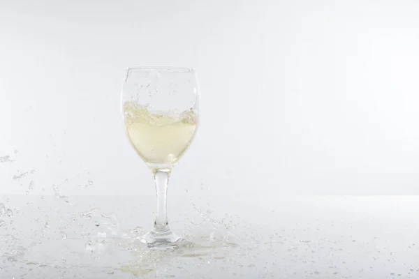 Champagne splashes and wine glass with copy space — Stock Photo, Image