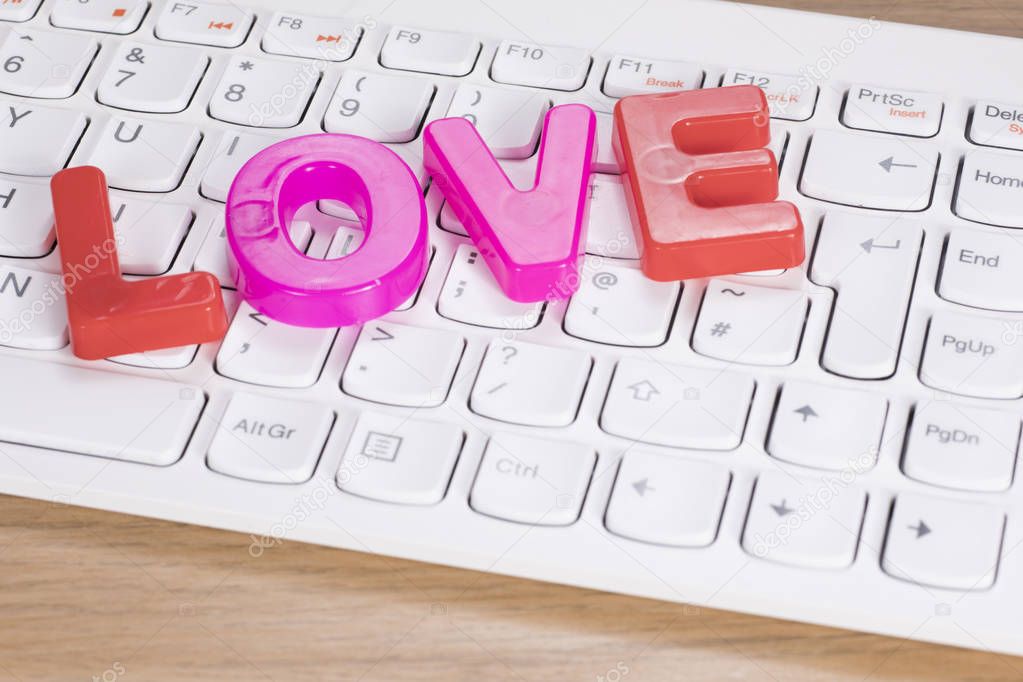 The word love over computer keyboard