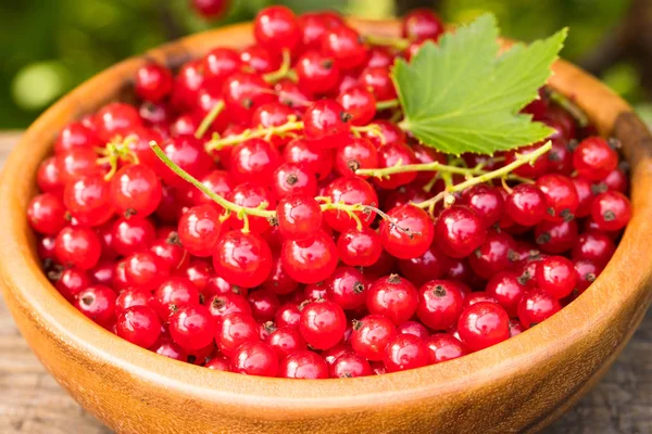 Grosella roja en cuenco de madera . — Foto de Stock