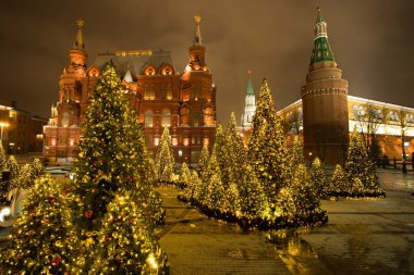 Moskova, Rusya. Tarihi Müzesi ve Moskova Kremlin ile güzel bir şekilde dekore edilmiş Noel ağaçları modacı Meydanı'nda akşam kış Moskova Devlet.