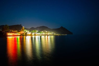 Night View On Coast With Illuminations On Black Sea With Reflect