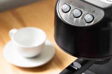 Close Up Of Coffee Maker With Buttons On Table Indoors.