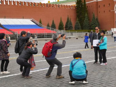 Moscow, Russia - April 27, 2018: Chinese Tourists Photographing On Red Square At Spring. Traveling In Russia.