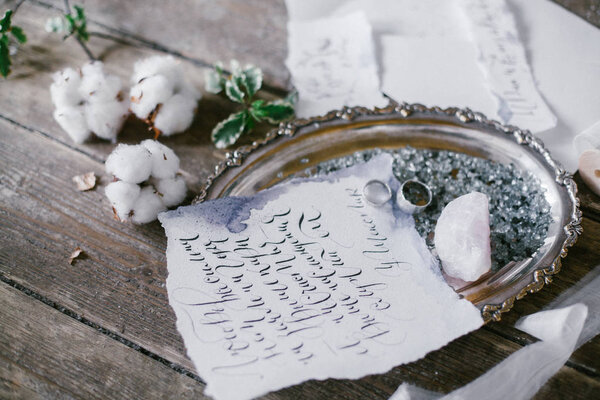 Graphic arts of beautiful wedding calligraphy cards and silver plate with two wedding ring.