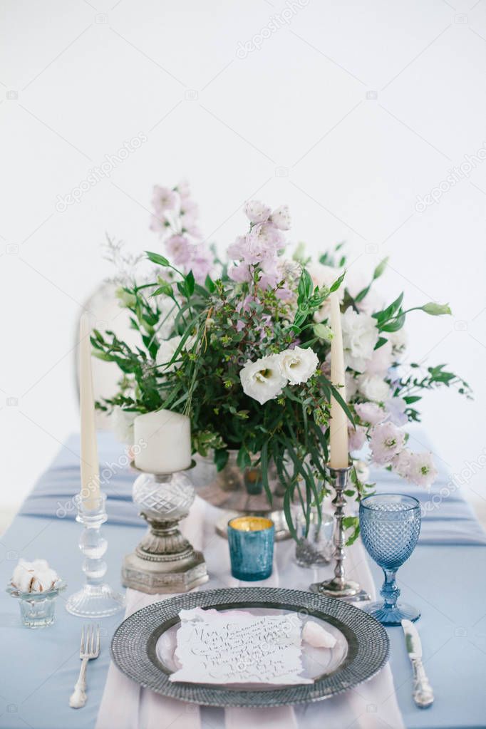Silver candlestick and other elements of festive table wedding decorations.