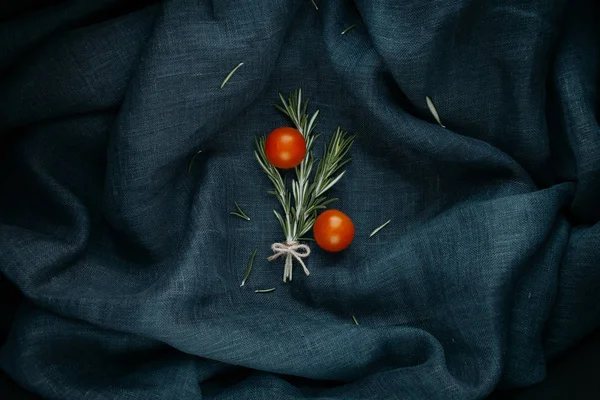 Stylish food. The rosemary and cherry tomatoes composition.