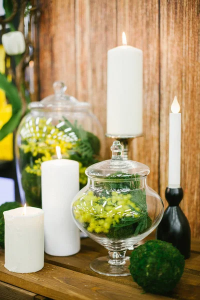 Candlestick with candle and mimosa in vase. — Stock Photo, Image