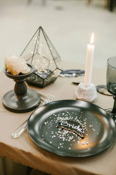 Wedding tableware with name card, stone candlestick with candle. — Stock Photo, Image