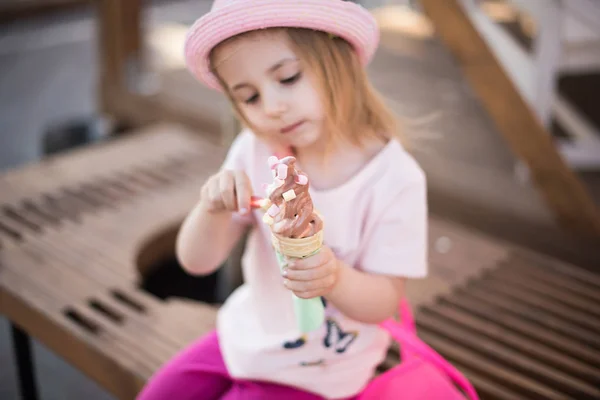 Szőke kis lány ül a fagylalt — Stock Fotó