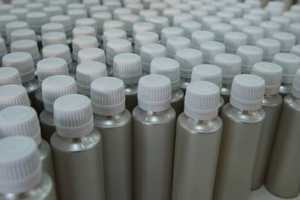 Plastic bottles on the assembly line of cosmetic pharmaceutical