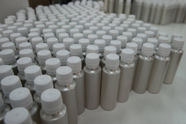 Plastic bottles on the assembly line of cosmetic pharmaceutical 