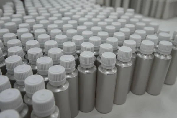 Plastic bottles on the assembly line of cosmetic pharmaceutical