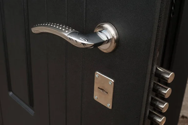 Lock in a metal black door — Stock Photo, Image