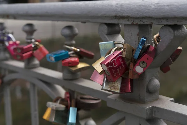 Padlocks on metal railing as symbol of love — Stock Photo, Image
