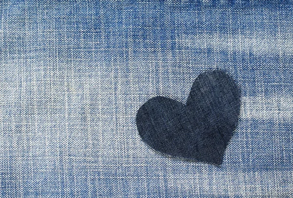 one stylish heart cut from blue denim in a trendy background