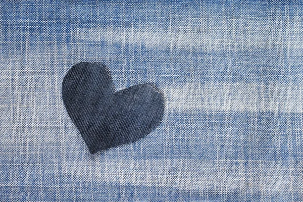 one stylish heart cut from blue denim in a trendy background