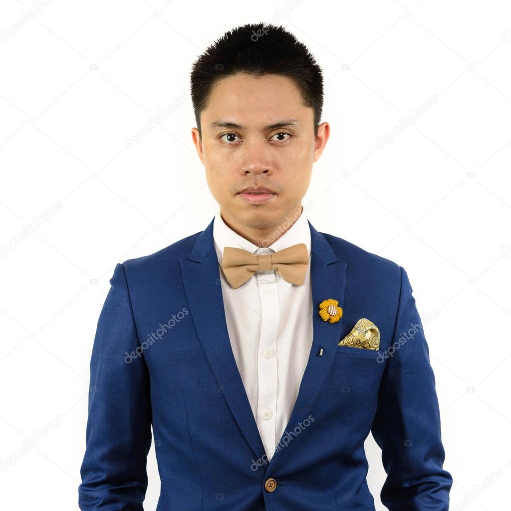asian man in blue suit bowtie, brooch
