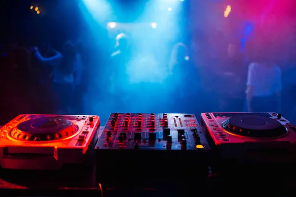 Remote and mixer DJ for music in the night club Stock Image