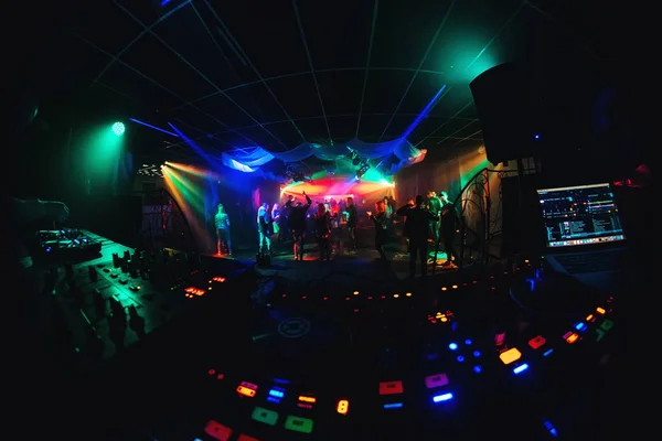 Dance floor and stage in night club with dancing crowd and DJ equipment and mixer — Stock Photo, Image