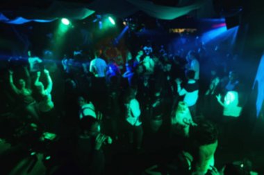 Konser gece kulübü yeşil aydınlatma ile dans pistinde insan bulanık siluetleri